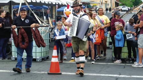 Rodney Kalich of the Sausagefest Committee and local musician Dave “Superdave” Hollas led the walking parade at the beginning of Saturday’s festival in downtown Schulenburg. More pics of Sausagefest fun appear today on page B2. Photo by Andy Behlen
