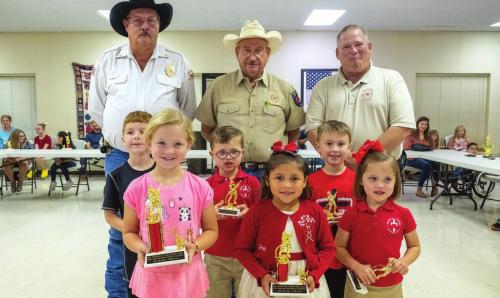 Fire poster contest winners for Pre-K and Kindergarten are (front, from left) first place - Stella Mozisek of La Grange, second place - Patsy Lemus of La Grange, third place - Macy Hodges of La Grange, (middle) third honorable mention - Adam Reeves of Schulenburg, second honorable mention - Cole Hodges of La Grange, first honorable mention - Brayden Rainosek of Schulenburg, (back) Keith Burcalow, Randy Noviskie and Kenneth Chovanec of the Fayette County Firefighters Association.