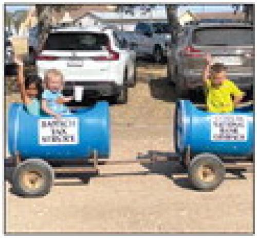Isabella and Hayden Bankhead and Blake Brown enjoyed the kids train rides at The Holy Cross picnic.