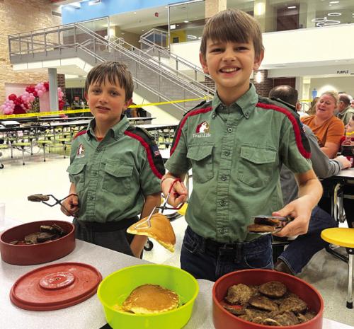 The La Grange Rotary Club held it’s 70th annual Pancake Supper Thursday with dine-in and drive-through options at the La Grange Elementary. Here’s a picture from the event, a couple of helpful scouts serving sausage patties and pancakes, part of a whole army of volunteers that helped make the event happen. Photo by Jeff Wick