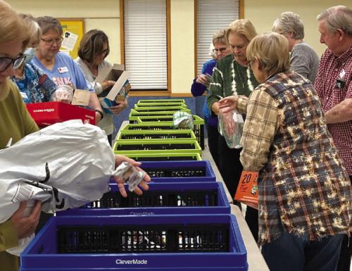 Members in attendance filled goodie bags for active Fayette County teachers and staff.
