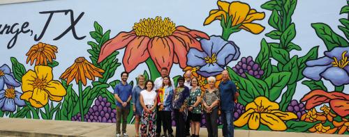 The City of La Grange held a dedication for the new mural on the side of the Meservey Building on Main St. Pictured are (front, from left) artists Avery Orendorf and Sullivan Meservey, Mayor Jan Dockery, Council members Kathy Weishuhn, Violet Zbranek and Ken Taylor, (back) Main Street Manager Caleb Parks, Peggy Johnson and Mark Meservey of Meservey Financial Services, and City Manager Jack Thompson. Photo by Andy Behlen