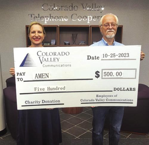 Funds donated by members of Colorado Valley Telephone Cooperative were donated to the AMEN Food Pantry. Pictured from left to right are: Colorado Valley Communications Director of Regulatory Affairs &amp; Marketing Karen Gunkel and AMEN Treasurer Garry Schellberg.