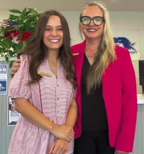 Fayette Savings Bank's Nicole and Sarah posing in pink to honor Dolly Parton.