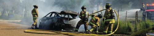 A car caught fire on the side of Hausmann Gin Rd. near US 77 after suffering a blowout on the highway Wednesday afternoon. The burning car started a small grass fire as well. La Grange firefi ghters put out the fires, but the car was a complete loss. Photo by Andy Behlen