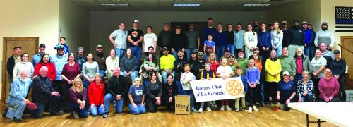 Some of the attendees at Saturday’s meal packaging event pose for a group photo.