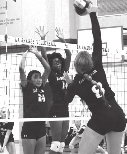 La Grange’s CiCi Barcenas and Tori Harold jump to try to block this hit by East Bernard’s Lexie Warncke Tuesday.