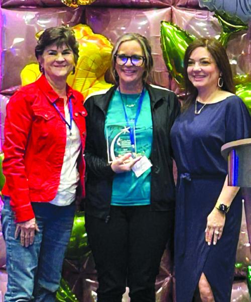 Nikki Gooch, center, receiving the The Wesley Nurse of the Year in recent ceremony.