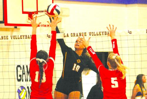 La Grange’s Camille Gonzalez goes up for a spike against the defense of a pair of Bellville player Tuesday. Gonzalez led the Lady Leps with five kills. Photo by Jeff Wick