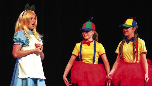 The La Grange 6th grade theater class under the direction of Erin Oppermann performed “Alice in Wonderland” at the Performing Arts Center Monday. From left to right is Ally Canada as Alice and Langley Murphy and Ruby Freedman as Tweedle-Dee and Tweedle-Dum. Photo by Meadow Taylor-Marklin
