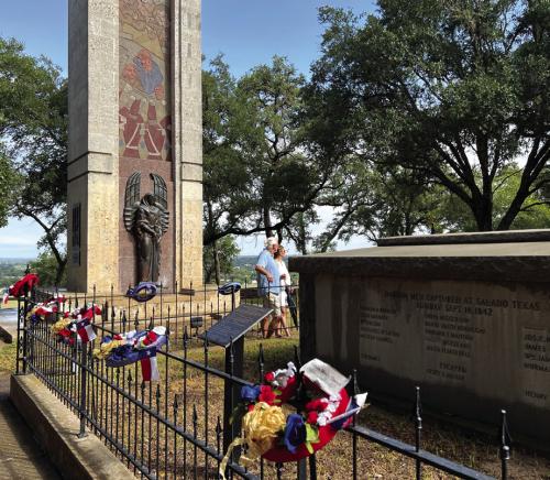 Visitors pause at the grave of Republic of Texas soldiers buried at Monument Hill. There final resting place is always adorned with wreaths on Texas Heroes Day.