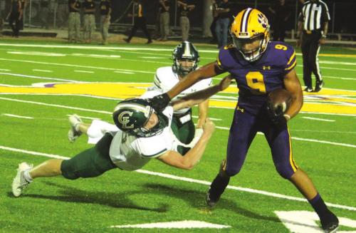 La Grange’s Jakobe Wilkerson pushes off a would-be tackler from Canyon Lake in Friday’s game. Photo by Jeff Wick