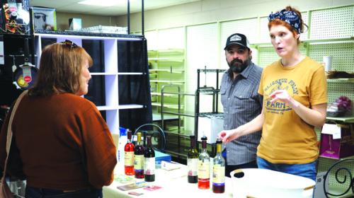 The 12th annual La Grange Uncorked wine festival was held Saturday in downtown La Grange as numerous Texas wineries were set up all around the courthouse square in businesses. Here Anthony and Melanie Lira extoll the virtues of various Rohan Meadery beverages to attendee Leigh Ann Bedient. Photo by Bobby Bedient