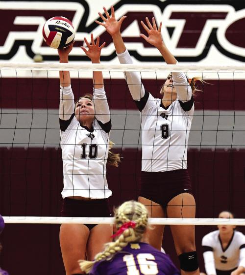 Katie Templeton (#10) blocks a Lady Wildcat hit for the Flatonia Lady Bulldogs in Tuesday night’s district matchup with Weimar. Also shown is Braidy Fike (#8). Photo by Stephanie Steinhauser