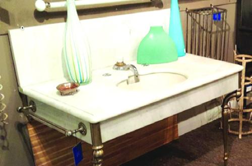 Marble sink with fancy legs, skirt, and backsplash, typical of the 1880s.