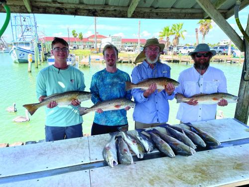 From left, my sons Sam and John with my dad, Kenneth Behlen, and myself after our recent fishing trip in Port O’Connor.