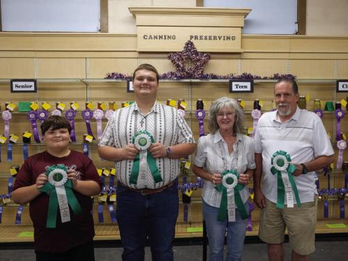 BEST OF THE CANNING AND PRESERVING DEPARTMENT From left, best of department in the child division went to Joseph Nigh for grape jelly; best of department in the teen division went to Jacob Nigh for marina sauce; best of department in the adult division went to Cathy Gau for pickled squash; best of department in the senior division went to Willie Gillie for tomato lemon jelly.