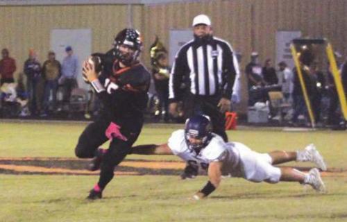 Schulenburg quarterback Brett Janecek scrambles away from this Shiner defensive player Friday. Photo by Brian Pierson