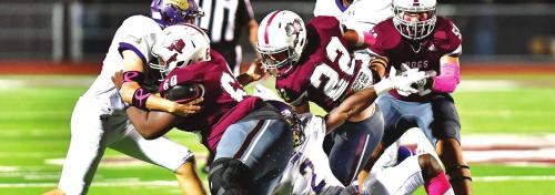 Aiden Gonzales (#22) carries for The Bulldogs while Kobe Burton (#60) and Ezequiel Rodrigues (#50) slow down Shiner defense. Photo by Stephanie Steinhauser