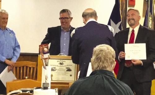 The SAR induction ceremony, left to right: Jack Muggli, registrar/ genealogist, Alex Thorne, chapter President, Tom Jackson, compatriot sponsor of new SAR inductee, Rotter. It is tradition to remove the SAR rosette pin from the President and pin it on the new SAR member.