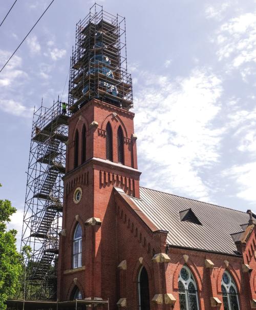 Workers with Cadillac Roofing of New Braunfels are clearly not afraid of heights. After a rain day on Tuesday, they were back to work Wednesday replacing the copper roof on the High Hill Church steeple. Photo by Andy Behlen