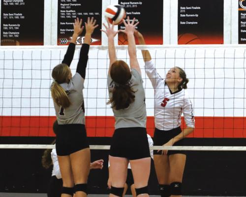 Schulenburg’s Brooke Redding battles at the net against a pair of Industrial players in Friday’s home match. Photo by Audrey Kristynik