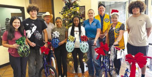 The La Grange Leo Club donated four bicycles with helmets to the Deputy Santa Program. Pictured from left to right are Natalia Soto, Mitchell Cervantez, Chief Deputy Randy Noviskie, Diamond McKenzie, Kaylee Holmes, Sgt. Angela LaLa, Michael Ahart, Diana Wilson, and Devante McKenzie.
