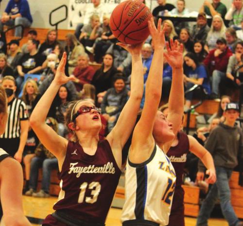Fayetteville’s Brooklyn Jaeger jumps for a rebound in Friday’s regional semifinal game. She scored 29. Photos by Jeff Wick