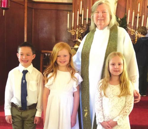 First Communion was celebrated by three individuals at United Evangelical Lutheran Church in Swiss Alp recently. Pictured here are first communion participants Hagan Brower, Parker Baumbach and Layla Aelmore along with Pastor Lemae Higgs.