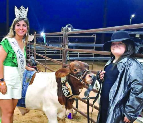 Kaylee Trejo, Miss Teen US Agriculture stopped for a picture with Rilan Karisch, dressed as The Undertaker and his beefmaster cross steer dressed as John Cena part of a costume contest at the fair.
