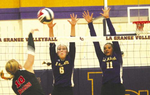 La Grange’s Gabby Hollek, center and Brion Williams, right, jump to block this hit by a Brazos player in Tuesday’s match. Photo by Jeff Wick
