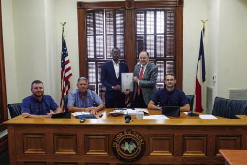 Dexter Jones of Mount Olive Baptist Church in Armstrong Colony was on hand for the proclamation signing last Thursday. Pictured (from left) are Pct. 4 Commissioner Drew Brossmann, Pct. 3 Commissioner Harvey Berckenhoff, Dexter Jones, County Judge Dan Mueller, and Pct. 2 Commissioner Clint Sternadel. Photo by Andy Behlen