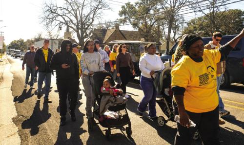 The group walking in the MLK Jr. Day March makes their way down Jefferson St. from Fayette Public Library on their way to the Courthouse. Photo by Andy Behlen
