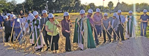 Hostyn church members, Bishop Brendan Cahill, Fathers Eddie Winkler, Paul Appiah-Otchere and Dan Kahlich, and others members of the design and construction team dig ceremonial shovels of dirt Saturday at the groundbreaking for the new church. Photos by Jeff Wick