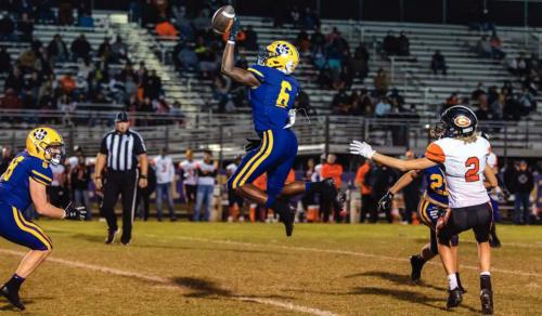La Grange’s Dana Baker leaps high to break up this pass in Friday’s game. Photo by Grace-Anne Matocha