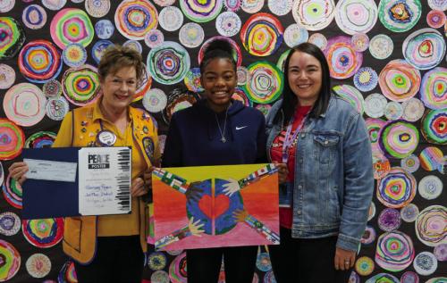Harmony Rogers (center) of La Grange Elementary School won third place at the district level of the Lions International Peace Poster Contest. She is pictured here with her artwork alongside Diana Wilson of the La Grange Noon Lions (left) and La Grange Elementary Art Teacher Brittni Keilers. Photo by Andy Behlen