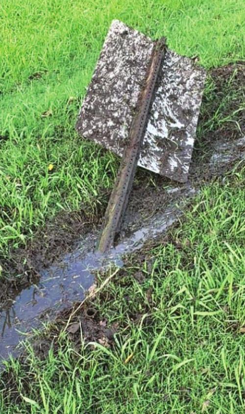 A downed sign, left, and ruts in the golf course, right, were damage from Monday’s mayhem at the La Grange golf course.