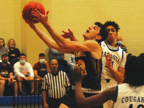 La Grange senior Caden Cooper drives to the basket in Tuesday’s 55-43 playoff victory over Jarrell in Rockdale. Photo by Jeff Wick