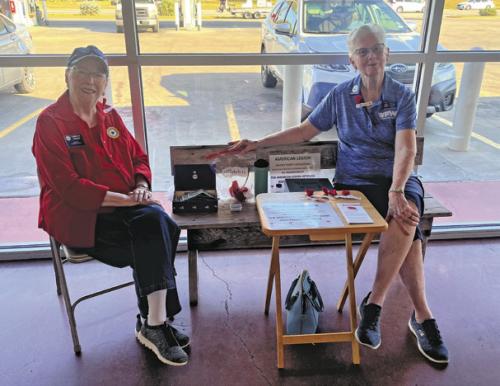 Carolyn Prause, left, and Twila Thurman, right, of the American Legion and VFW Auxiliaries were selling Buddy Poppies Friday at Weikel’s in La Grange in honor of Veterans Day weekend. The poppy is the official memorial flower of the Veterans of Foreign Wars of the United States and funds from the sales go to help veterans aid organizations. Photo by Jeff Wick