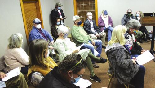 Shots of the crowd gathered, left, at Wednesday’s Fayetteville’s town council meeting, and right, the town council. Photos by Jeff Wick