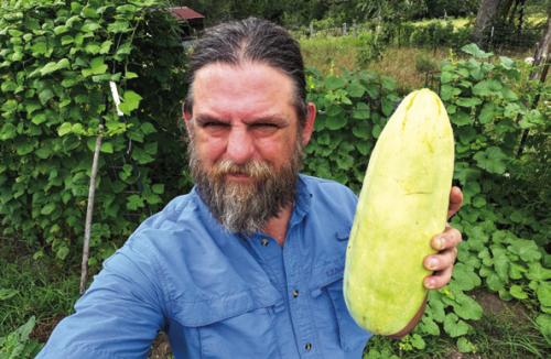Andy Behlen with a whopper of an Xylangouro melon, which tastes a lot like cucumber.