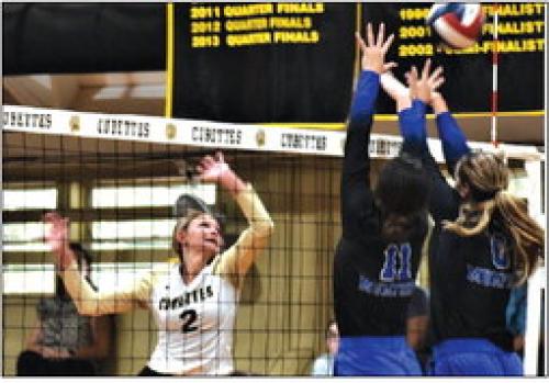 RT-C’s Tess Eilers hits a ball over a Mumford block in Tuesday’s victory. Photo by Paul Kipp