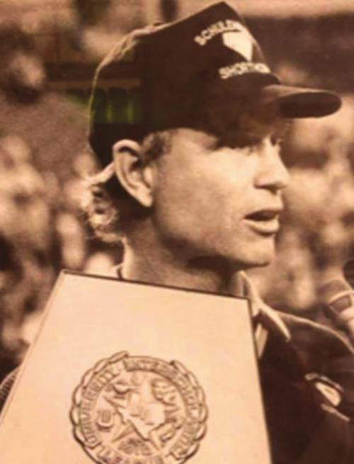 David Husmann is shown here holding the state title trophy and being interviewed after winning one of the two football titles he led the Shorthorns to.