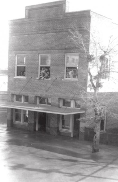 1913 floodwaters rose past this building that is now the eastern half of Hengst Printing and Office Supplies at 155 W. Travis Street in La Grange. Dark areas along the lower walls show that floodwaters had already receded about eighteen inches by the time this photo was taken. Photo courtesy of the Fayette Heritage Museum and Archives