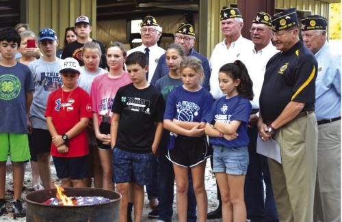 American Legion Post #338 with assistance for Carmine 4H students dispose of an American Flag as part of the Disposal Ceremony held in association with the Carmine Chamber of Commerce Night Out on October 6, 2022