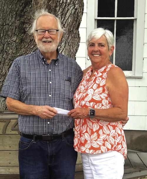CASA Treasurer Phil Oestreich received a donation from St. John Council Rep. Sharon Fritsch