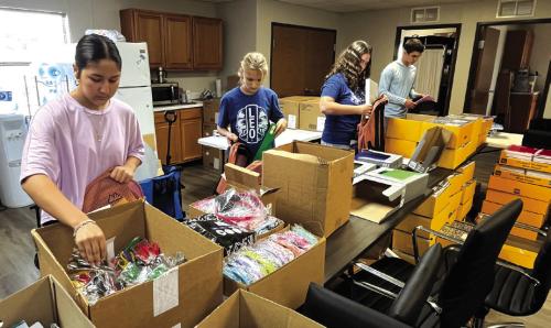 This Saturday, Tejas Healthcare will again host its free annual Back to School Festival. Wednesday volunteers, many of them students (some shown above), packed 600 backpacks full of school supplies that will be given away at the event. The supplies were made possible thanks to donations from area businesses, churches and service organizations. Saturday’s festival will be Saturday, Aug. 1 from 10 a.m. to Noon at the Tejas Healthcare Community Garden at 753 E. Travis Street in La Grange. Photo by Jeff Wick
