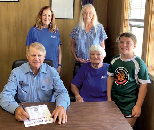 Ellinger Mayor Matt Mikulenka signed a proclamation presented by KJZT Family Life Society 41 of Ellinger designating June 14 as National Flag Day in Ellinger.