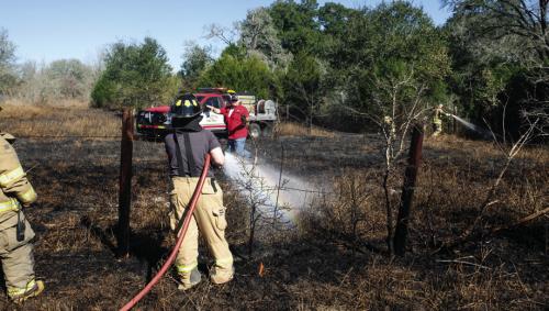 Ellinger and La Grange Volunteer Fire Departments battle a grass fire near the intersection of SH 71 and Kitchen Ln. Photo by Andy Behlen