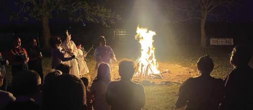 Many Catholic Easter Vigil Masses the night before Easter begin with a ceremony around a fire like this one outside Holy Rosary Church in Hostyn Saturday. The fire symbolizes the “light of Christ, rising in glory,” scattering the “darkness of our hearts and minds.”